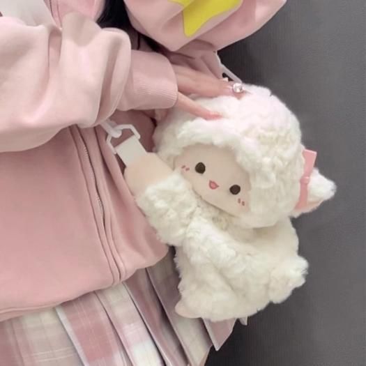 Small cream Cute Lamb Plush Bag with zipper closure worn by person in pink hoodie
