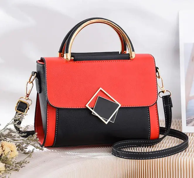 Stylish red and black oblique crossbody women's bag with gold handle and adjustable strap