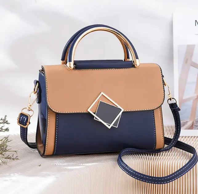 Oblique Cross Women Bag in navy and tan with adjustable strap and geometric clasp