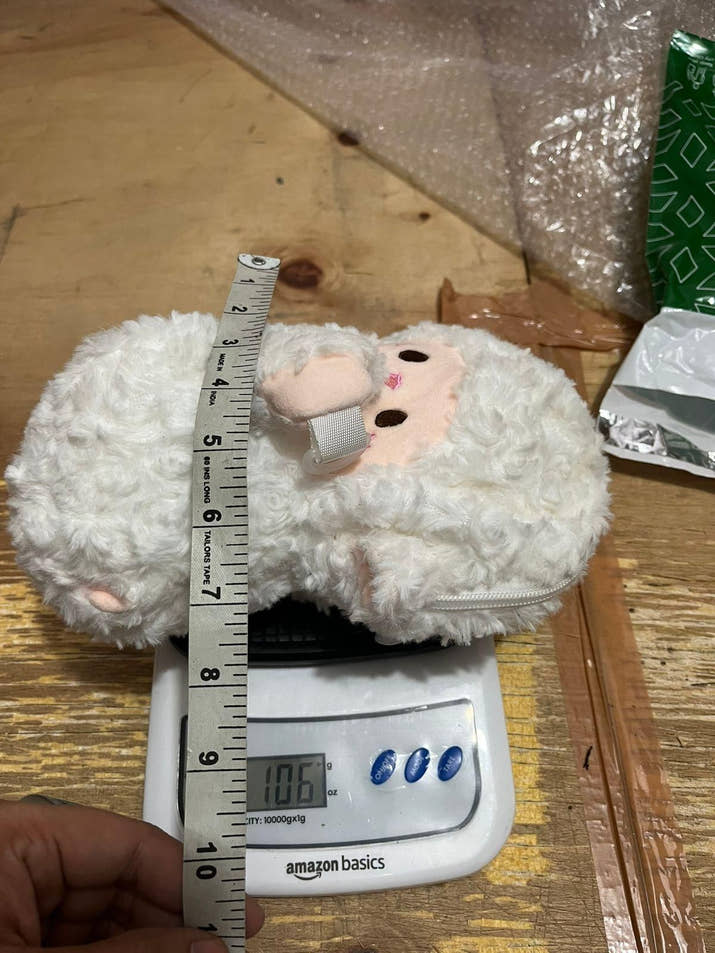 Cute Lamb Plush Bag small cream color ultra-soft plush sling bag with zipper closure and one compartment on digital scale and measuring tape showing size and weight