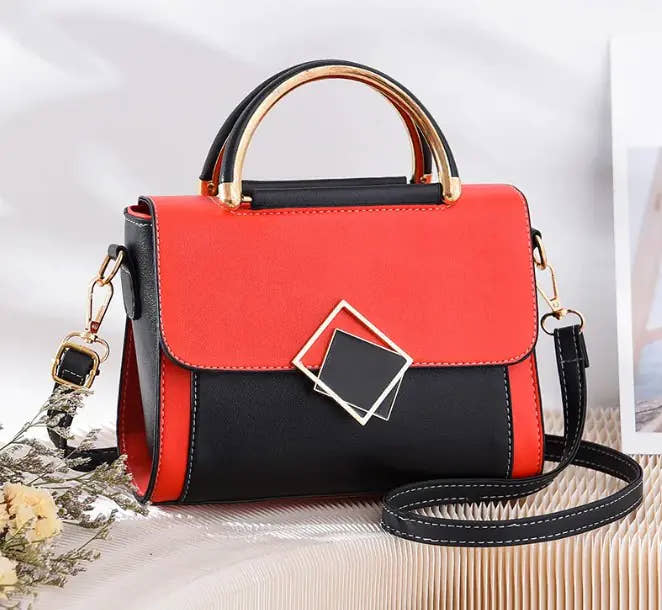 Stylish red and black oblique crossbody women's bag with gold handle and adjustable strap