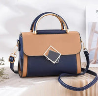 Oblique Cross Women Bag in navy and tan with adjustable strap and geometric clasp
