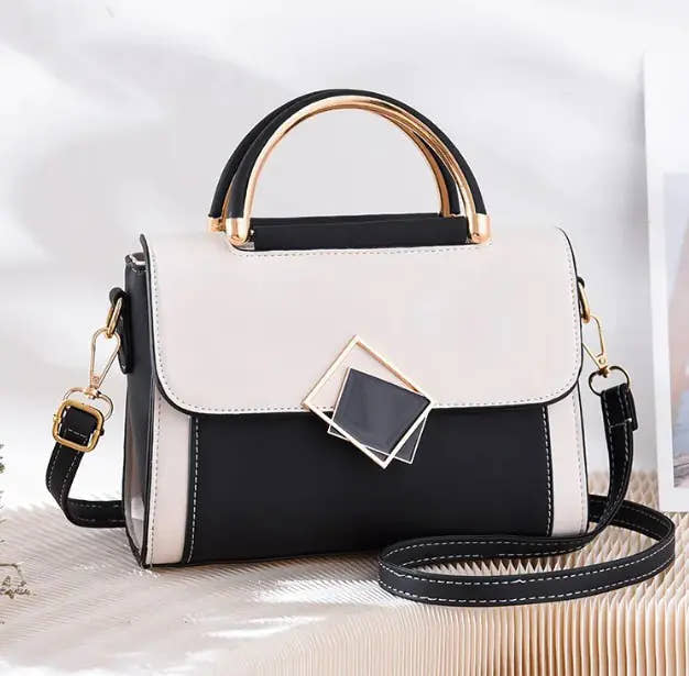 Stylish oblique crossbody women bag in black and white with gold handle and adjustable strap