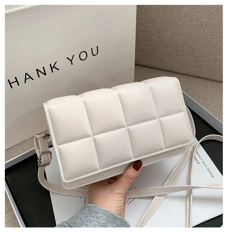 White women shoulder bag with quilted leather design and adjustable strap