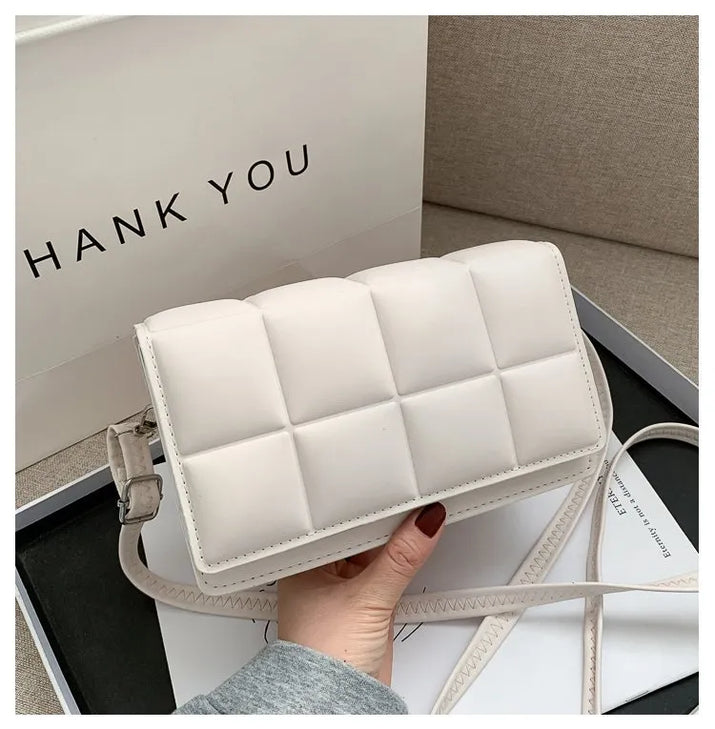 White women shoulder bag with quilted leather design and adjustable strap