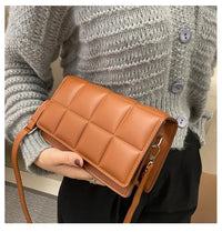 Women leather shoulder bag with quilted design and adjustable strap, stylish and compact accessory